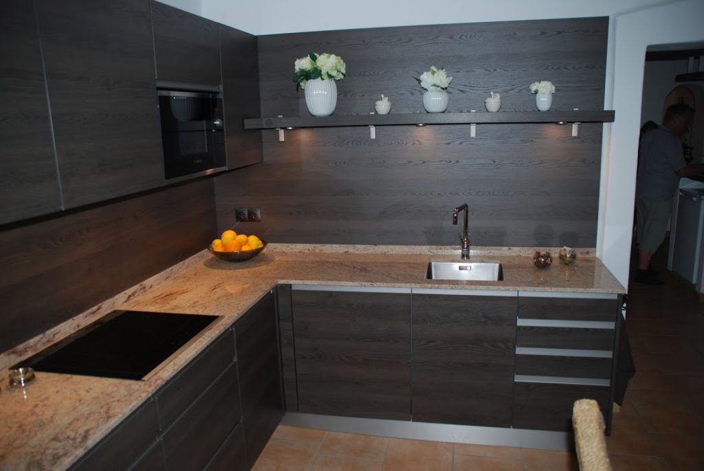 Dark style wooden kitchen with marble countertop
