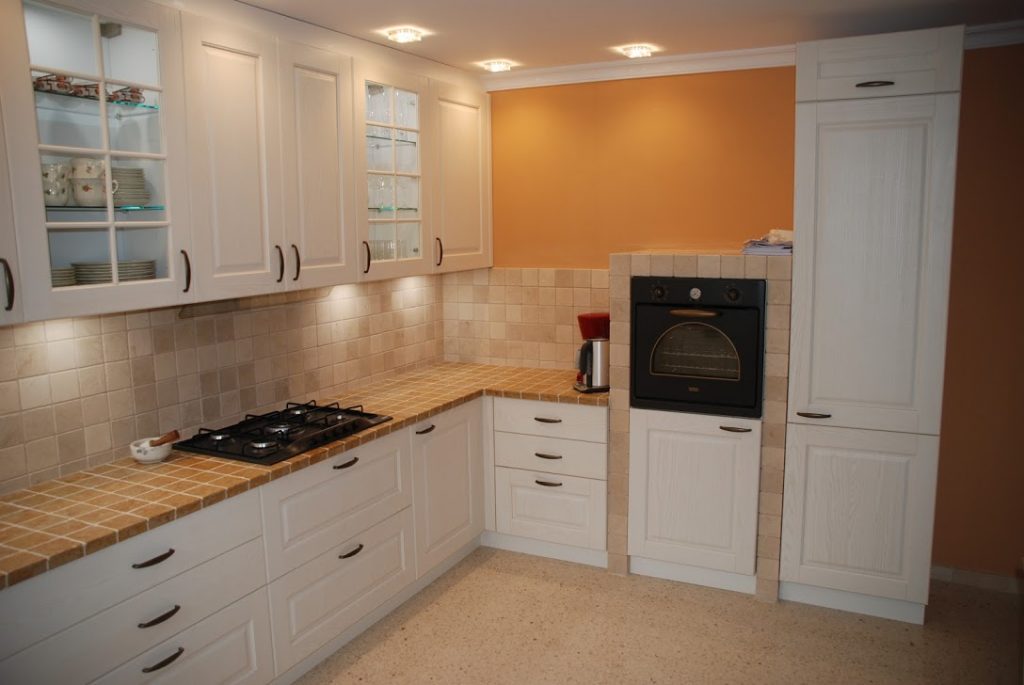 Tiled kitchen after renovation with yellow walls